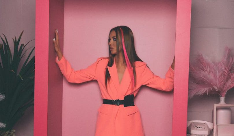 portrait of woman posing in large doll box