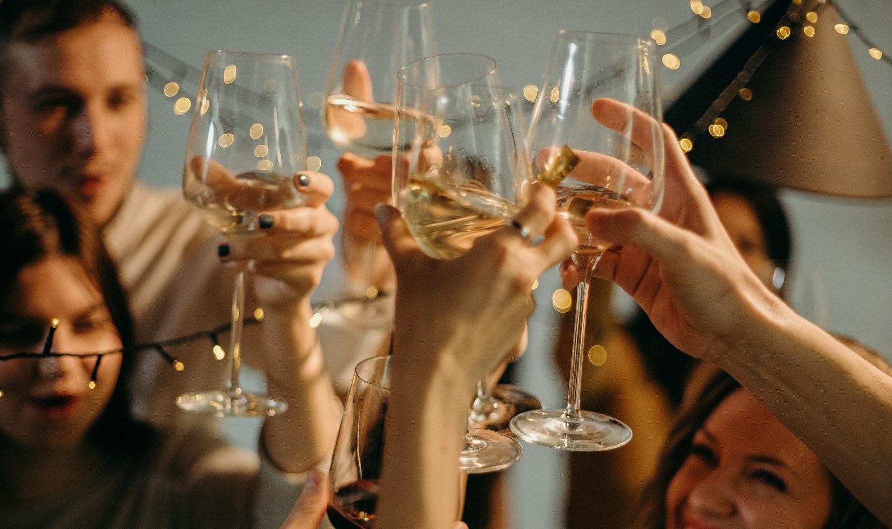 selective focus photography of several people cheering wine glasses