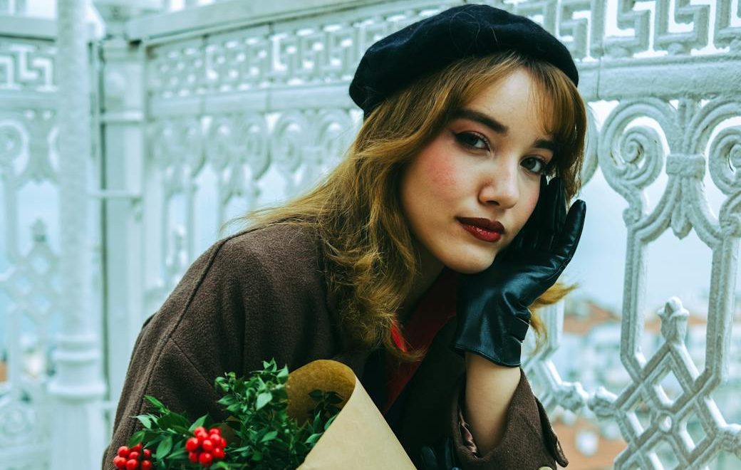 stylish woman in vintage winter fashion with bouquet