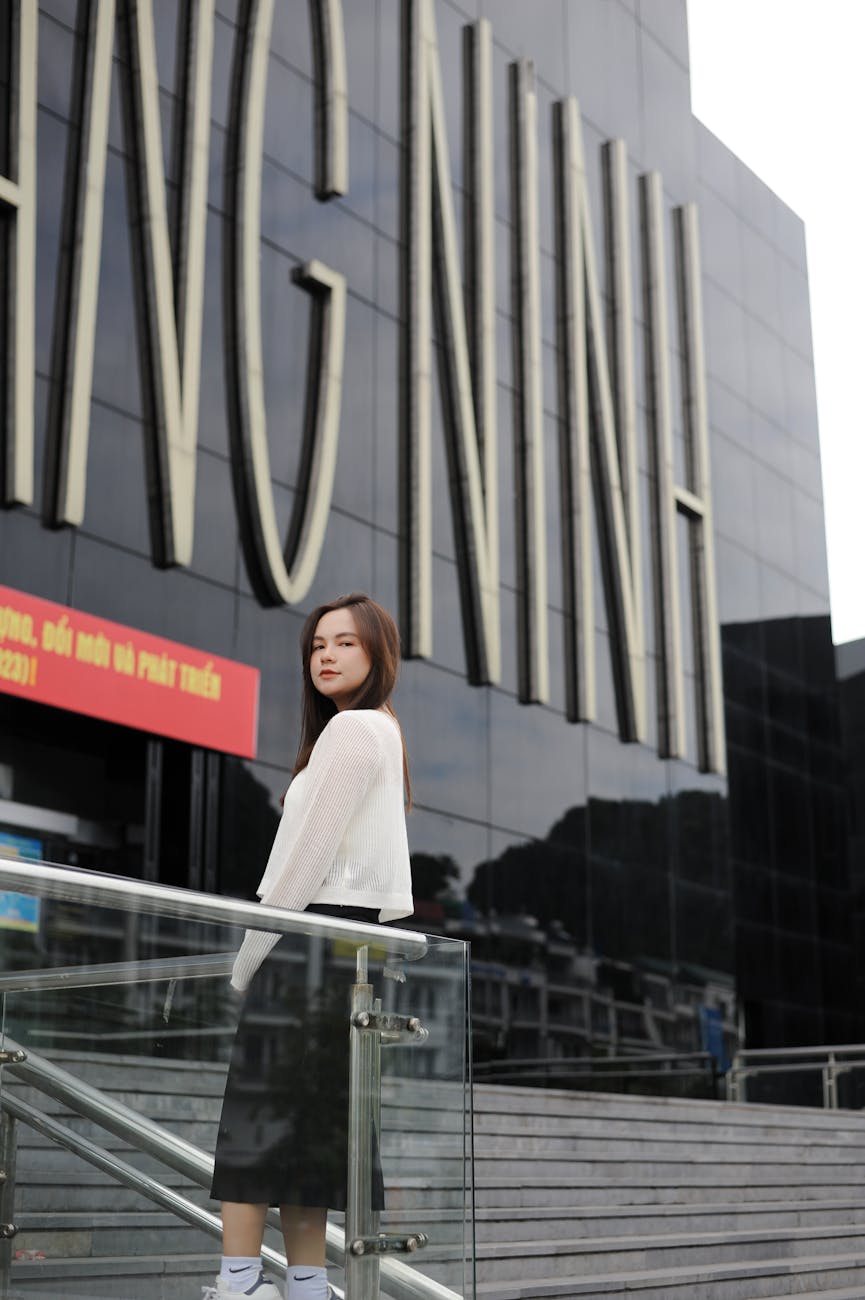 woman standing by modern building facade